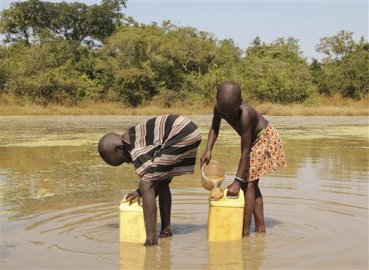 Children in the village of Lengjak in southern Sudan collect drinking water from a pond using filters provided to them by The Carter Center's guinea worm eradication program.
